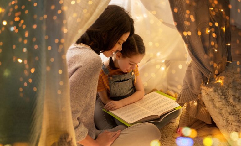 Mother reading with daughter a book